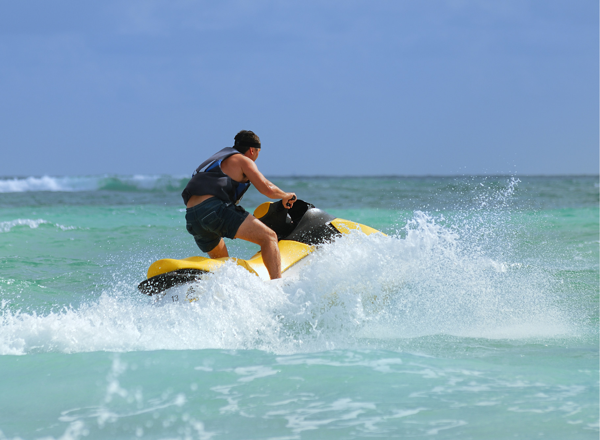 Guest riding a jetski on open water