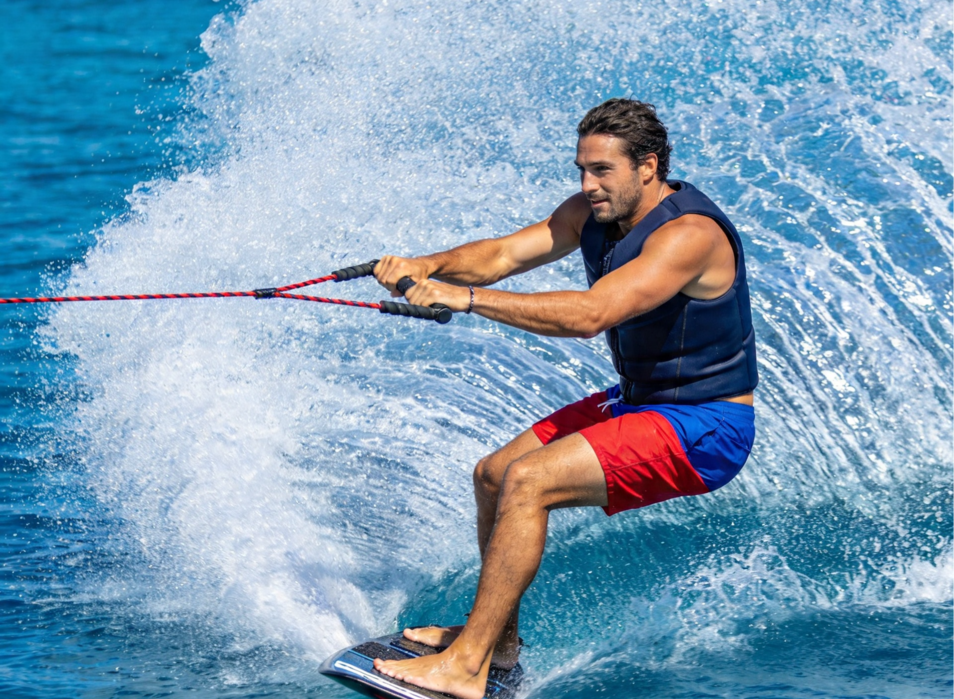 Wakeboarder being towed behind a boat